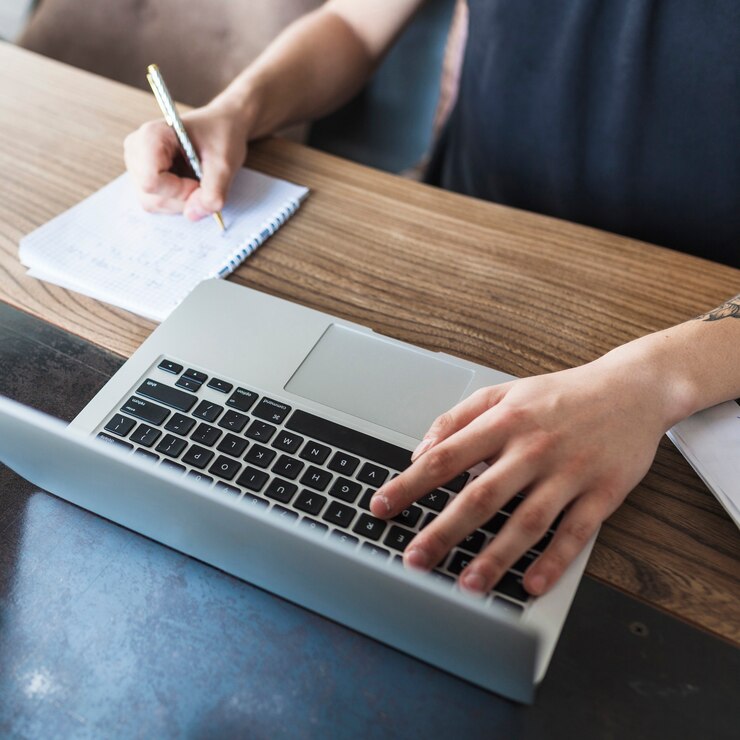 person-working-laptop-wooden-table_23-2147962633